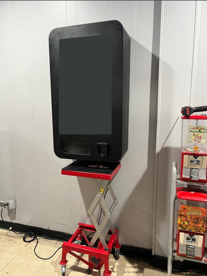 VapeTM hydraulic lift raising a vending machine to mounting height to reduce labor and injury